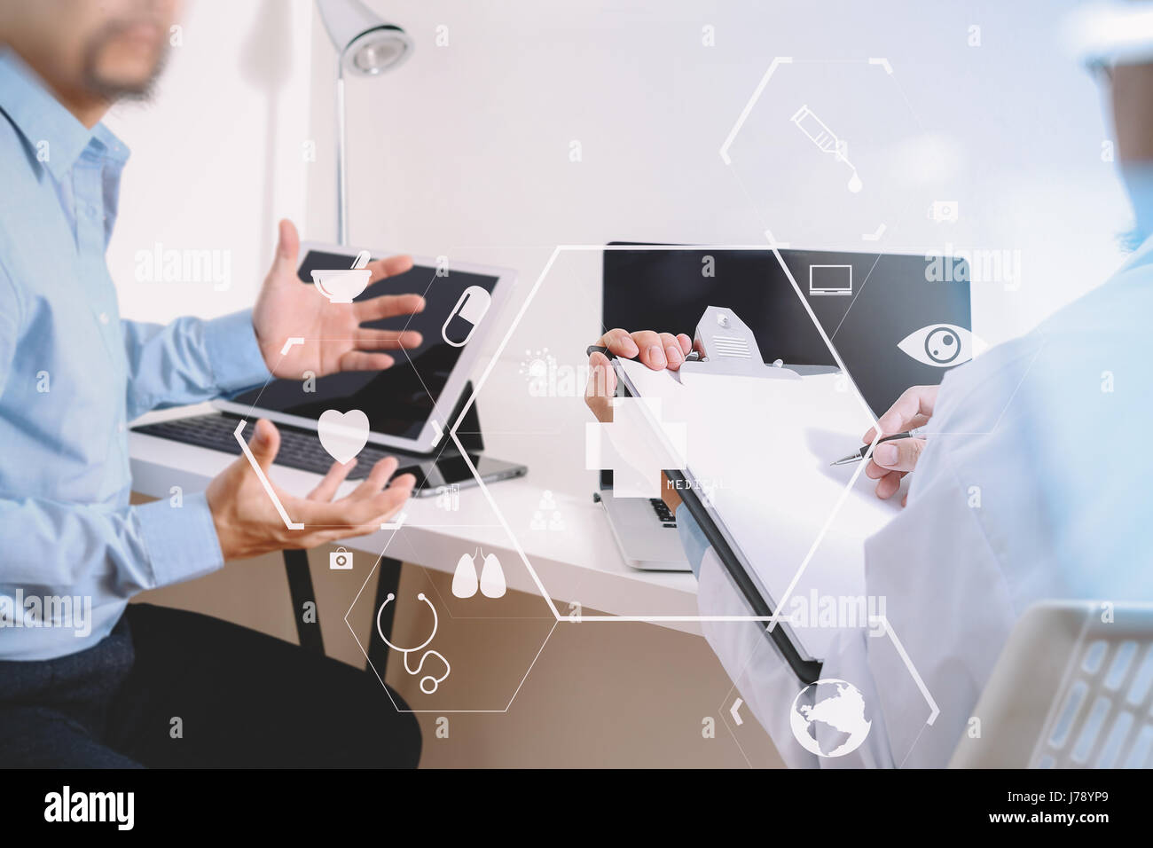 Medical doctor in white uniform gown coat consulting businessman patient having exam as Hospital professionalism concept with VR icon diagram Stock Photo
