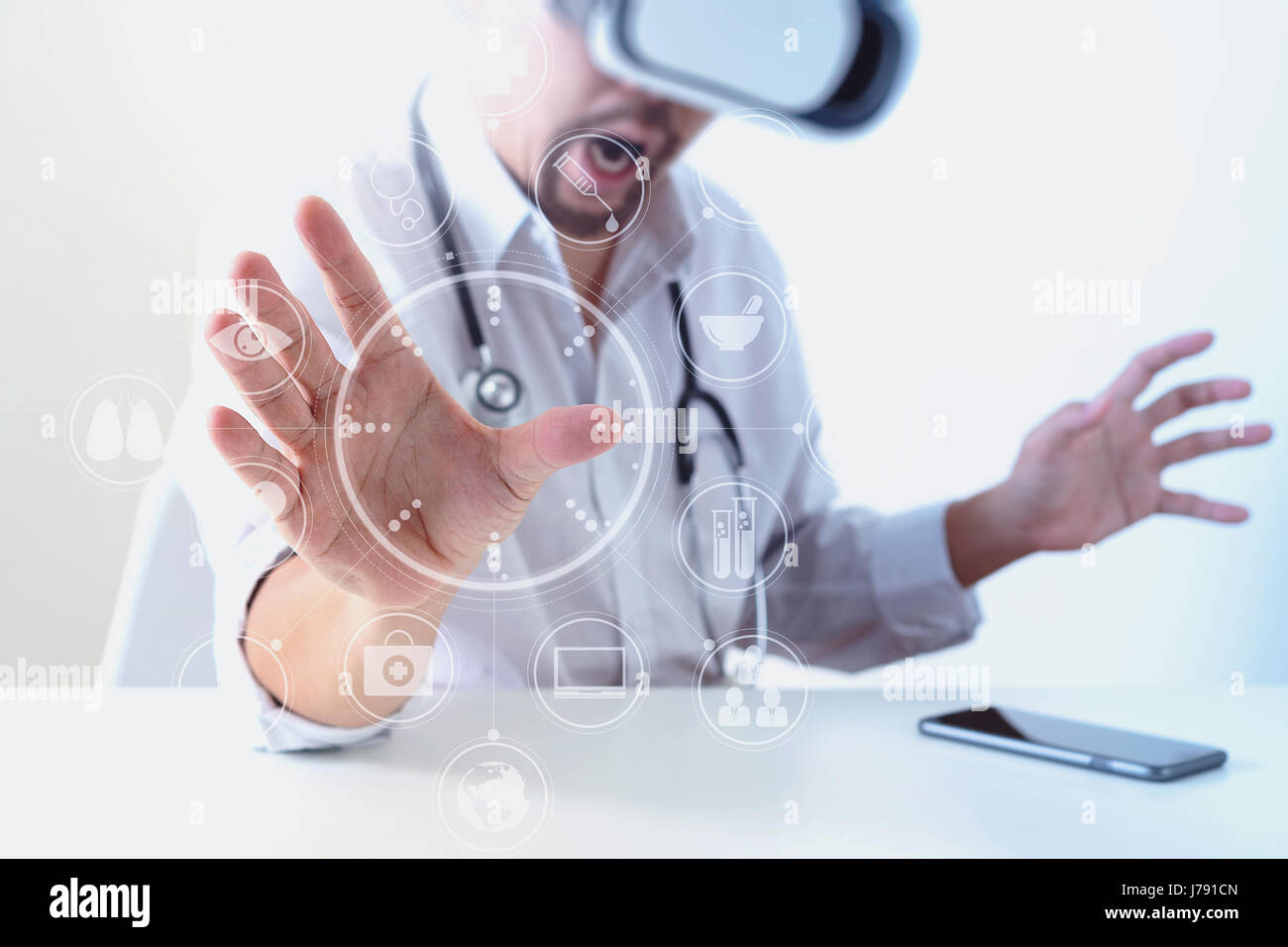 smart doctor wearing virtual reality goggles in modern office with ...