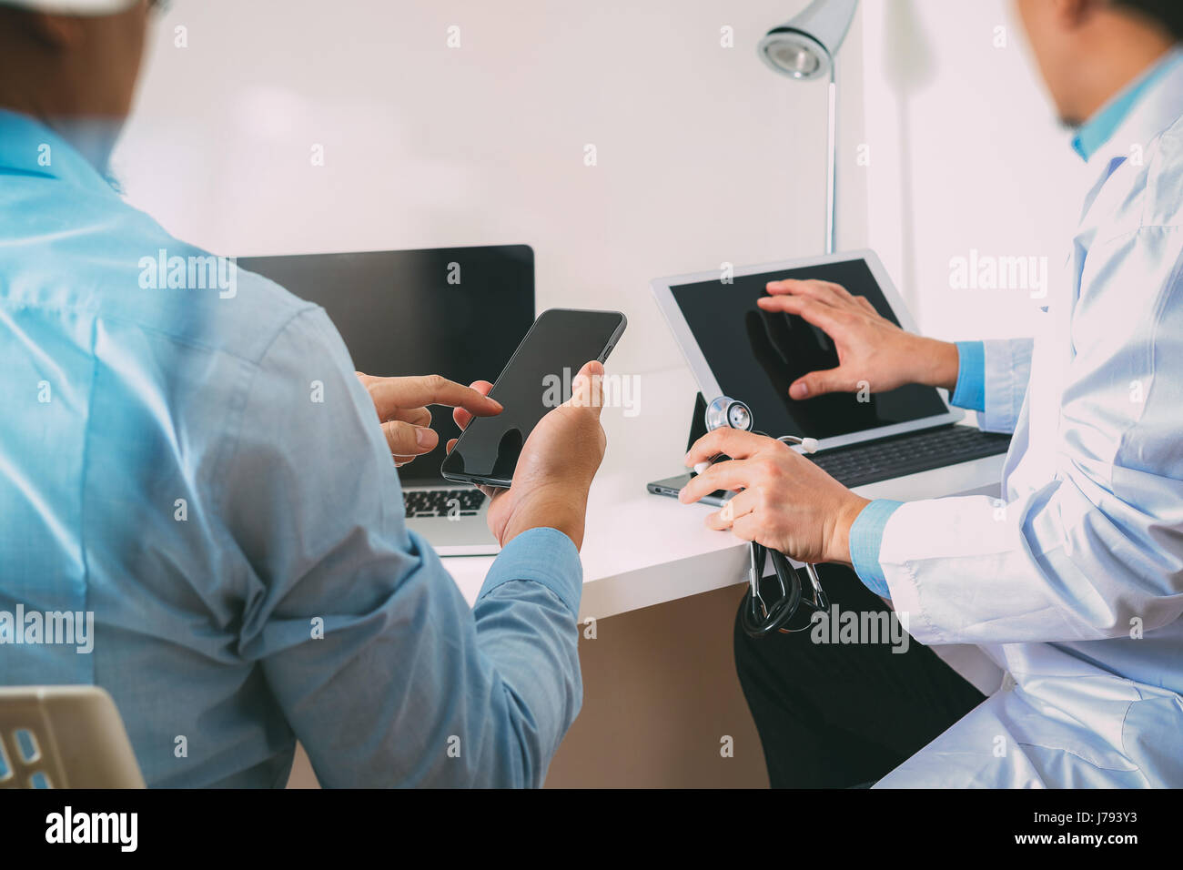 Medical doctor in white uniform gown coat consulting businessman patient having exam as Hospital professionalism concept Stock Photo