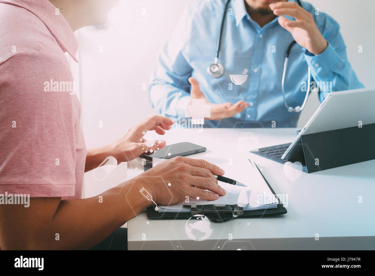 Medical doctor using mobile phone and consulting businessman patient having exam as Hospital professionalism concept with VR icon diagram Stock Photo