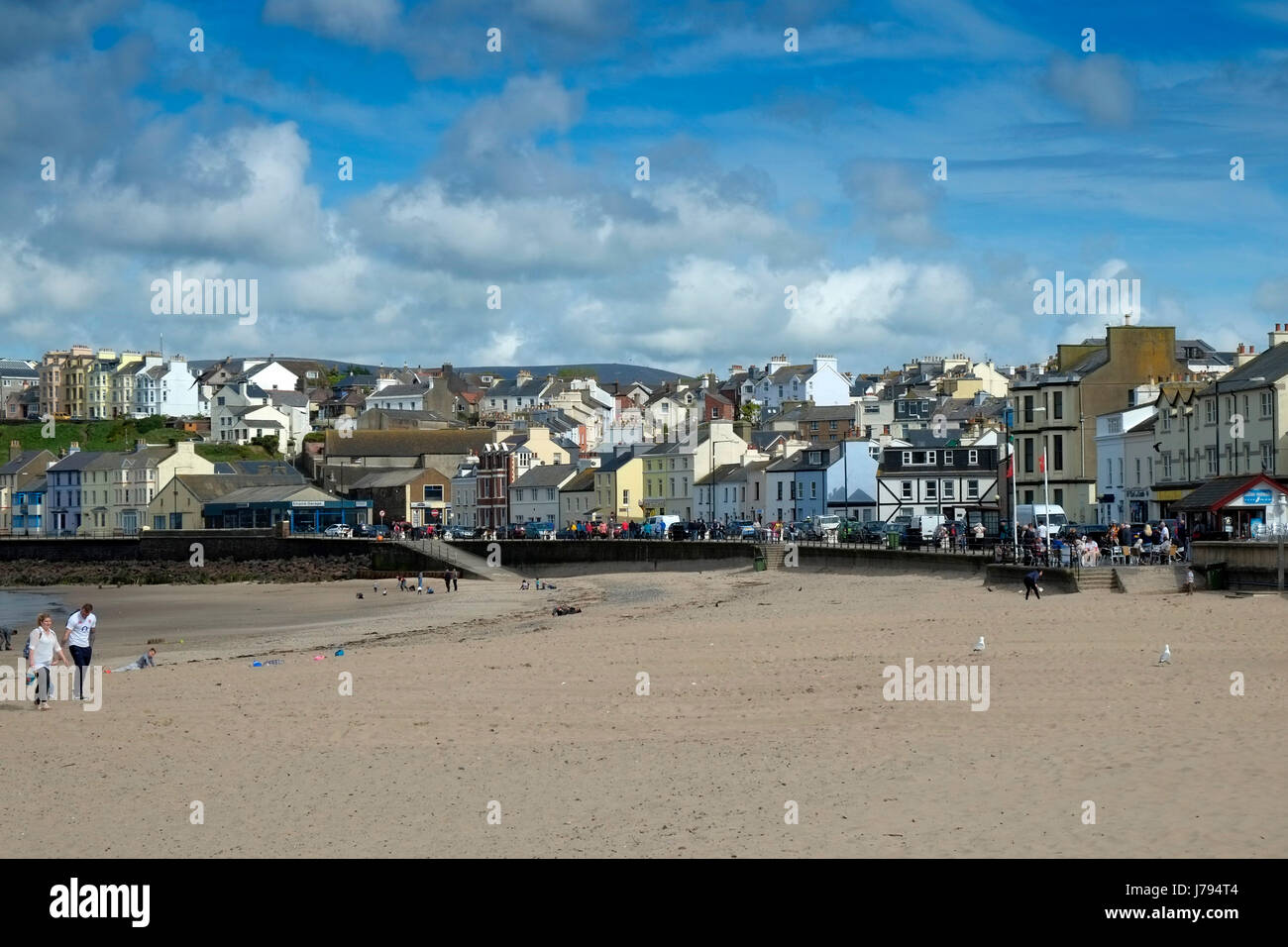 Peel, Isle of Man showing the promenade, harbour, castle and dredging