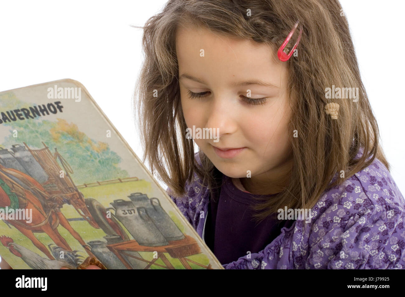 six year old girl reading a book (mr) Stock Photo