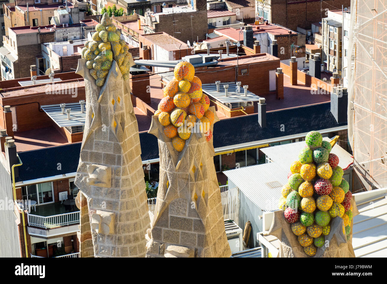 Ornamental sculptures on the pinnacles of three spires of Gaudi's Sagrada Familia Basilica in Barcelona Spain. Stock Photo