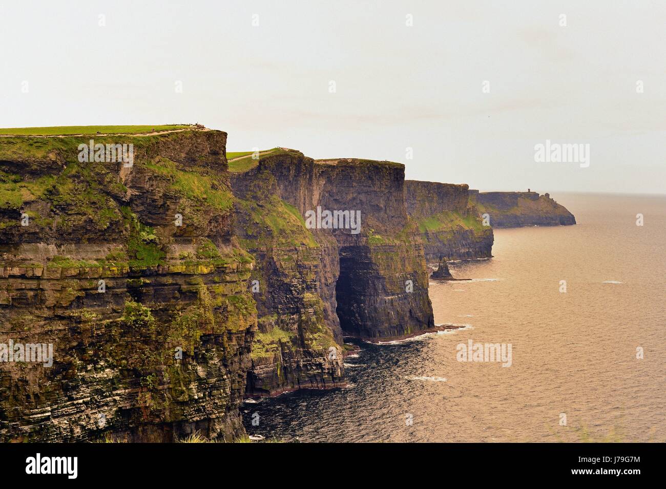 The rugged and brooding Cliffs of Moher near Liscannor, County Clare, Ireland. The cliffs are an unspoiled landmark symbol of the country. Stock Photo
