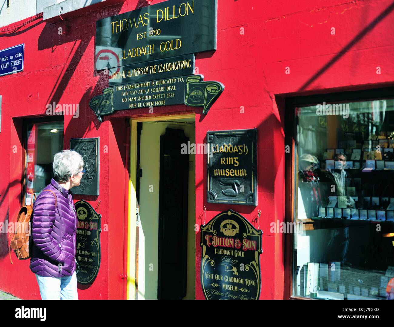 Shopper contemplates a colorful shop in Galway, County Galway, Ireland. , Stock Photo