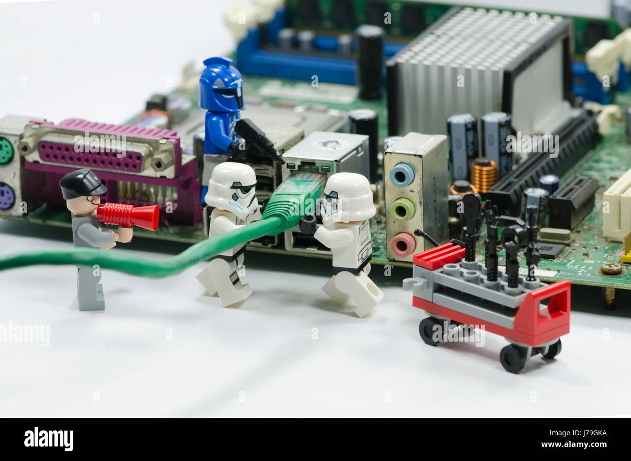 lego starwars minifigures working to plug in internet cable to the port on  motherboard Stock Photo - Alamy