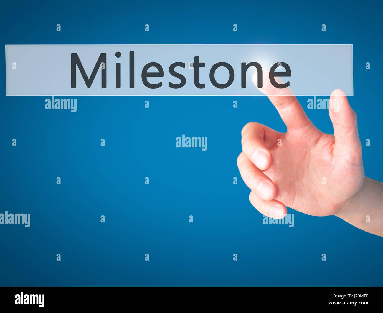 Button Milestone Milestone - Hand pressing a button on blurred background concept ...