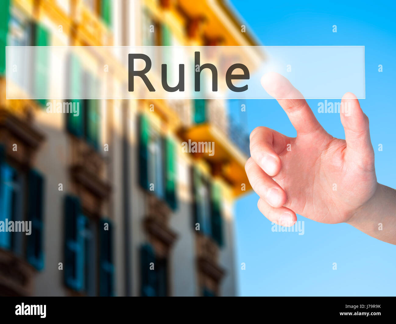 Ruhe (Quiet in German) Hand pressing a button on blurred background