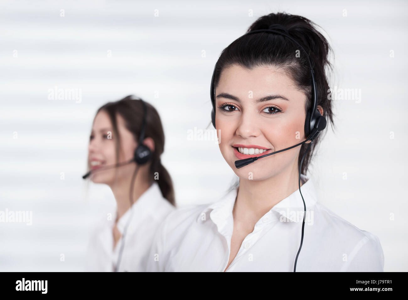 Female call center operator working in office Stock Photo
