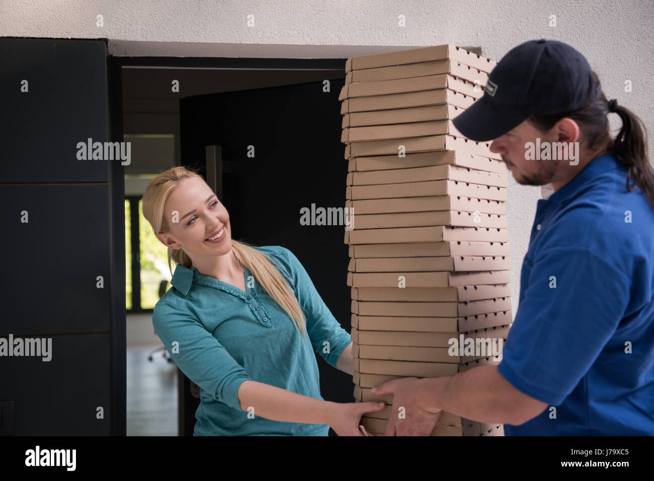 Pizza Delivery Man Giving Pizza Boxes To Smiling Young Woman Stock ...