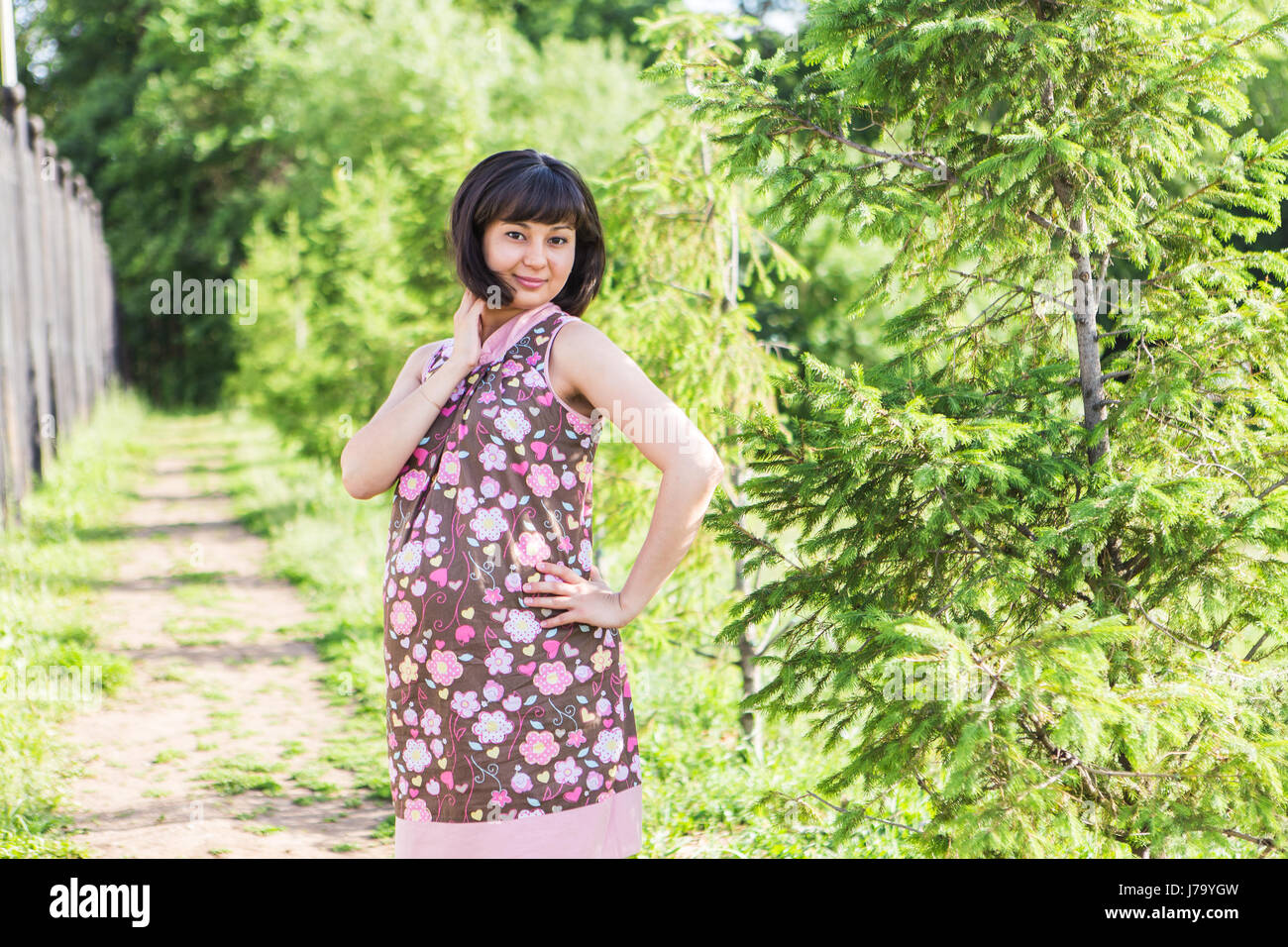 Pregnant woman posing in the summer park Stock Photo - Alamy