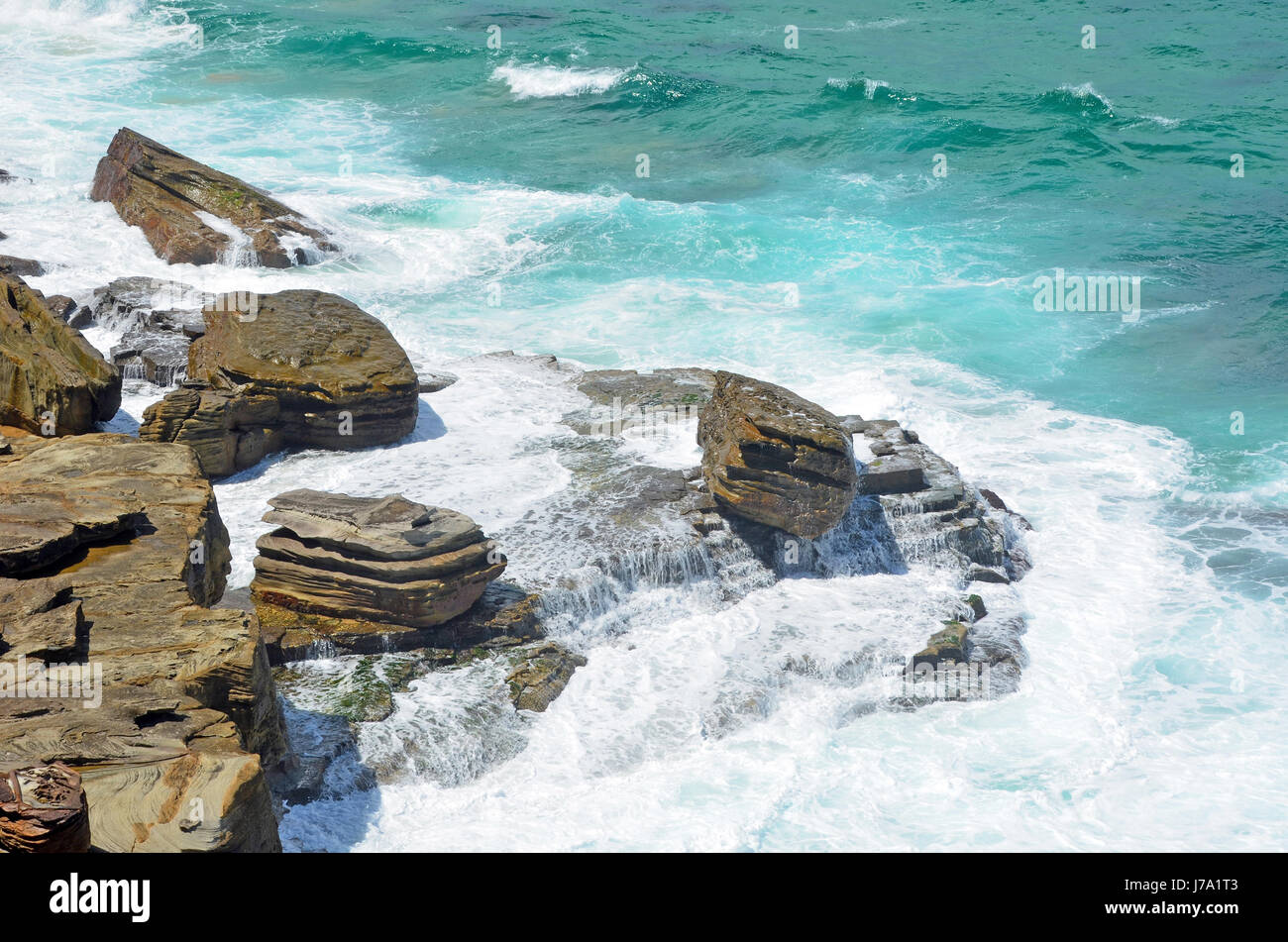 Waves crashing over sandstone rock platforms on NSW coast at Garie Beach, Royal National Park, Sydney Stock Photo