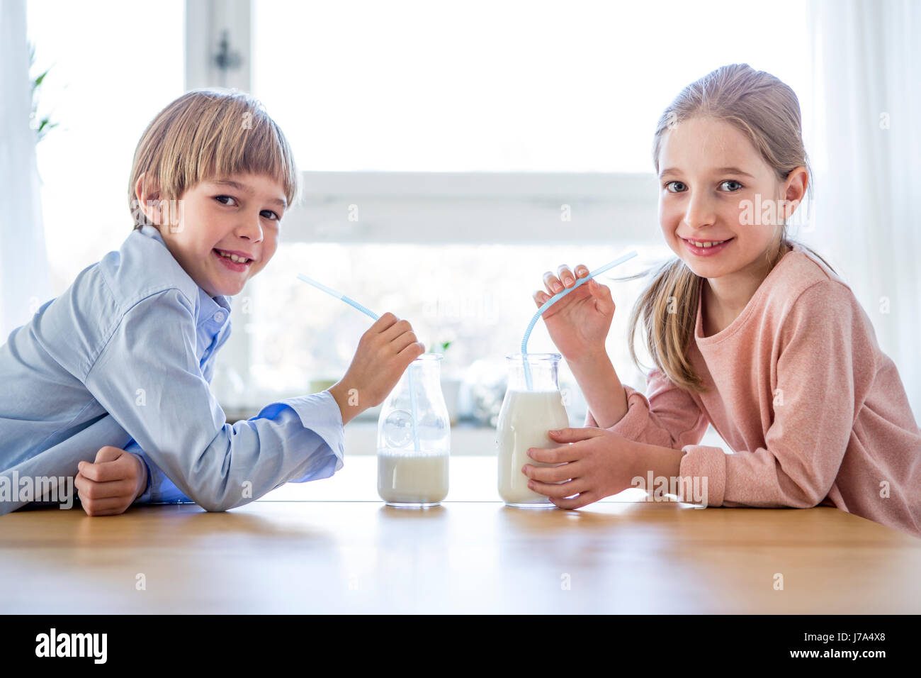 Brother and sister drinking milk Stock Photo - Alamy
