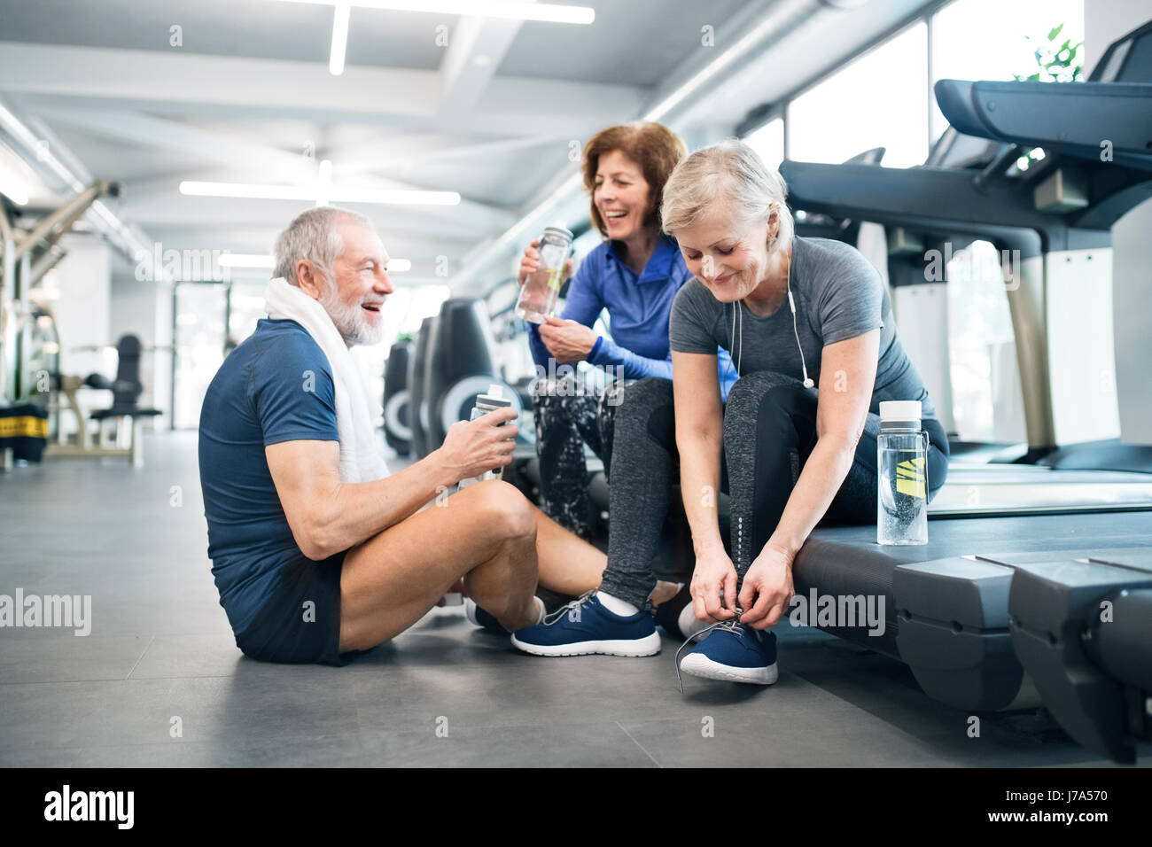 Group of fit seniors in gym resting after working out Stock Photo - Alamy