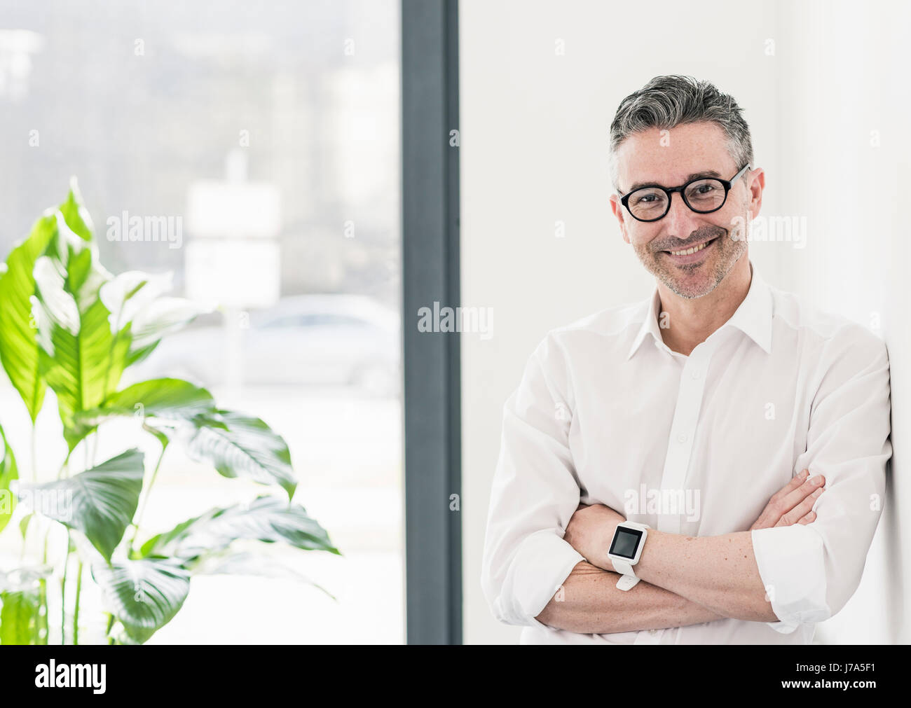 Portrait of smiling businessman wearing smartwatch and glasses Stock ...