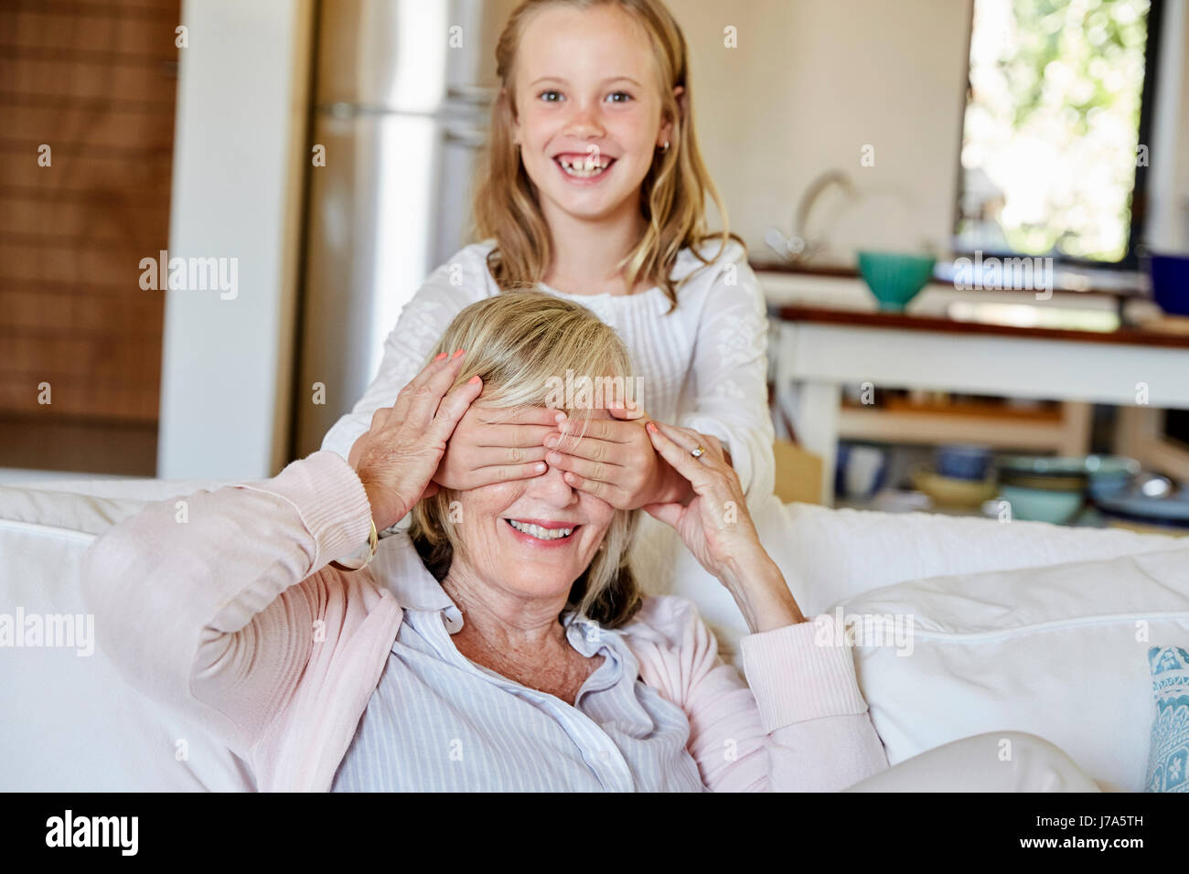 Little girl having fun with her grandmother at home Stock Photo - Alamy