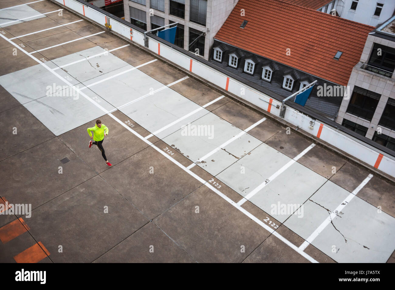 Young man running on parking level Stock Photo