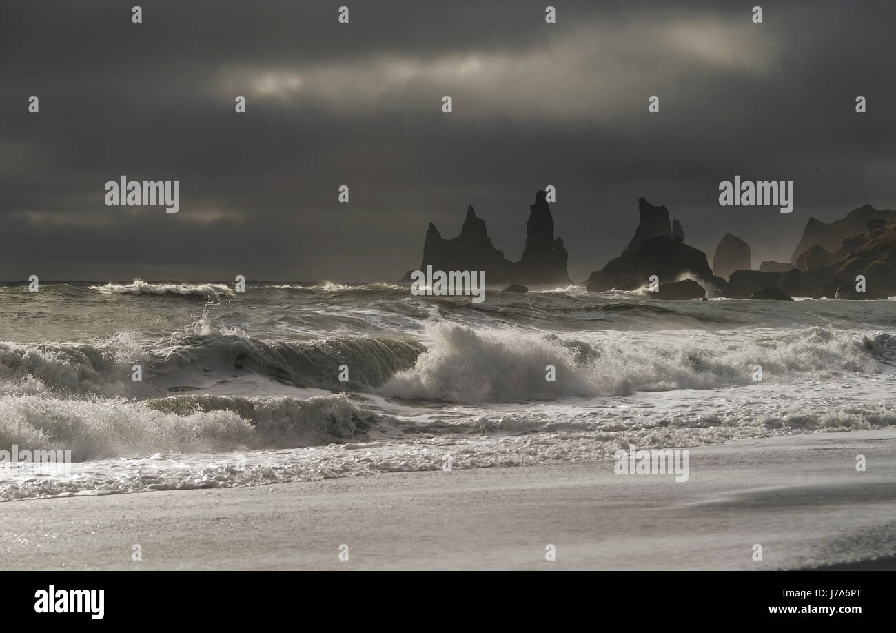 Iceland, Stone trolls and beach of black sand in Vik. Stock Photo