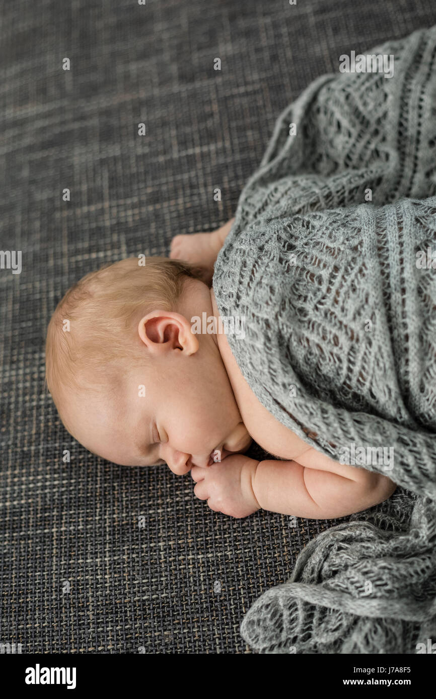Newborn baby boy sleeping on couch Stock Photo Alamy