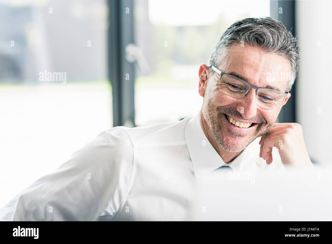 Portrait Of Smiling Businessman With Stubble Wearing Glasses Stock