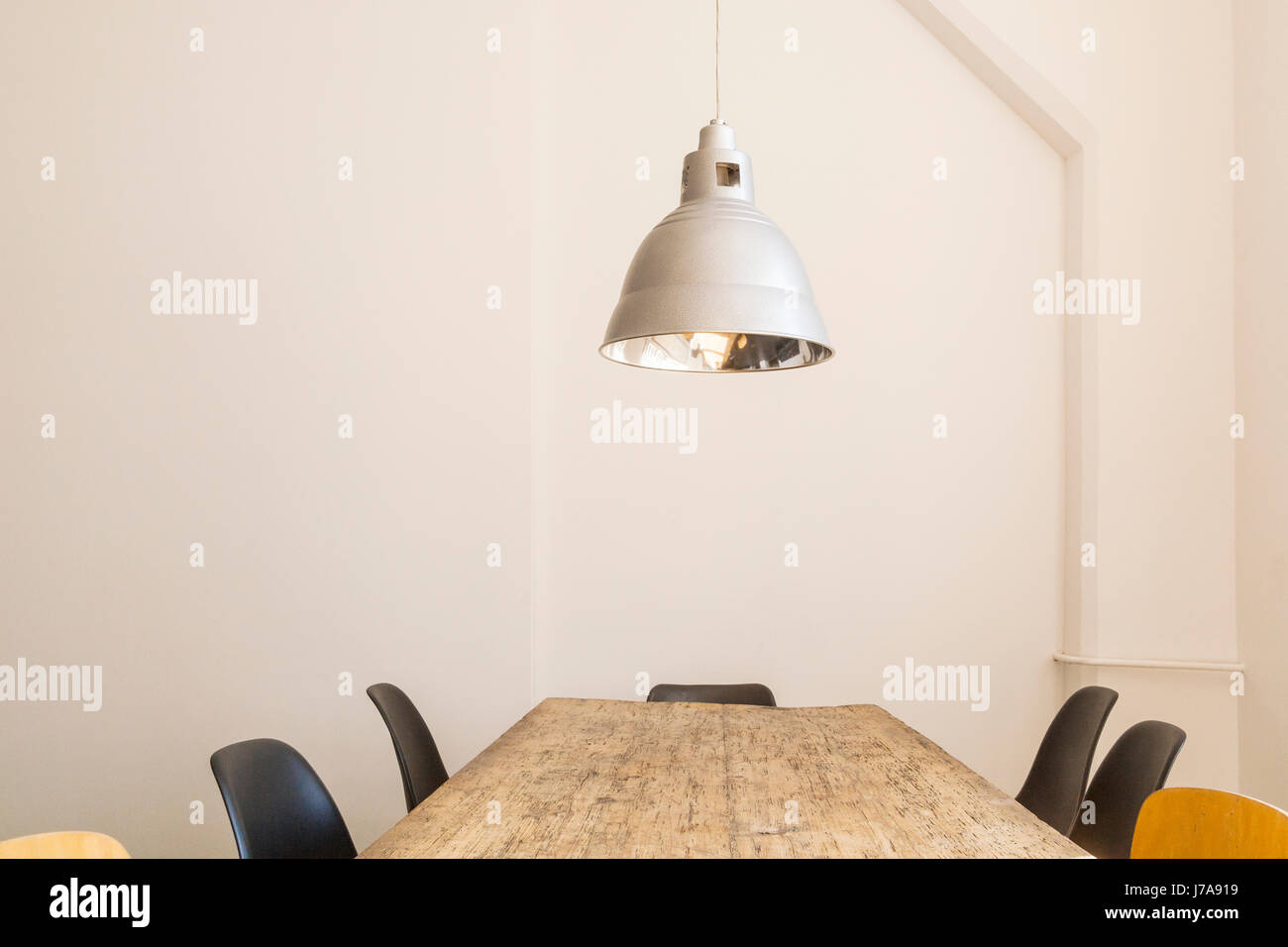 Conference table and ceiling light in a loft Stock Photo