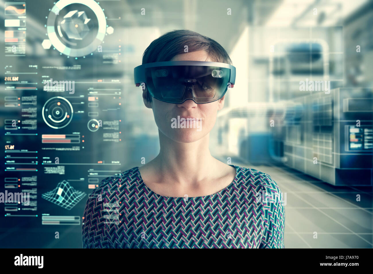 Woman wearing mixed reality smartglasses at transparent screen Stock Photo