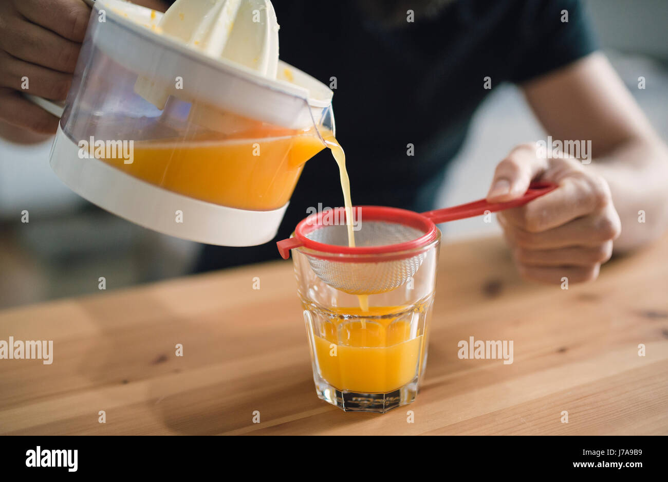 Filtering fresh orange juice Stock Photo