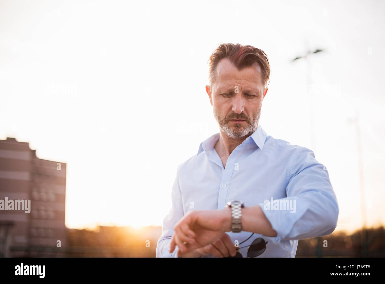 Portrait of mature man checking the time Stock Photo