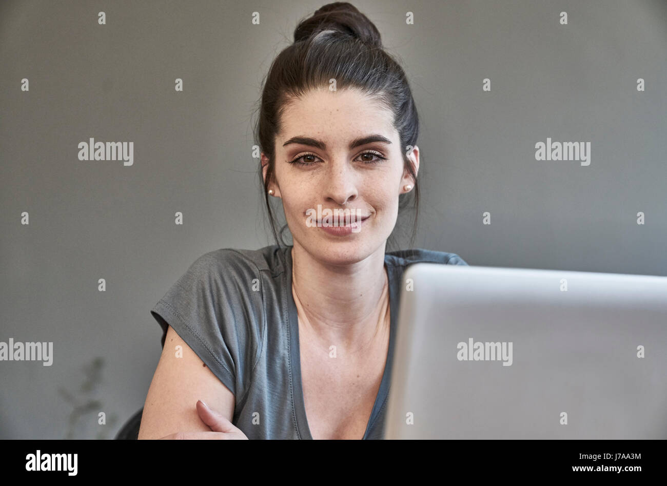 Portrait of smiling young woman with laptop Stock Photo - Alamy