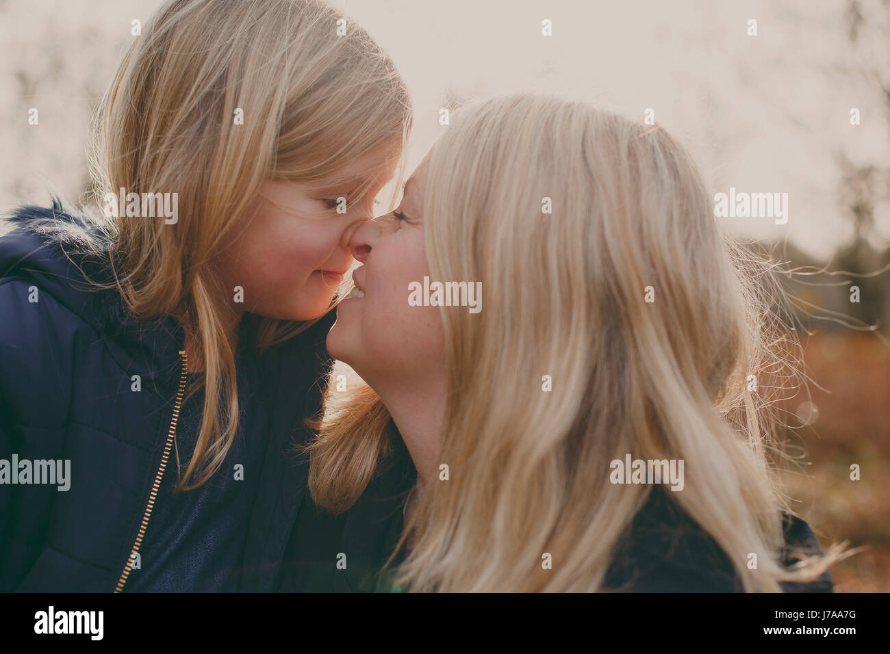 Mother and daughter touching noses Stock Photo