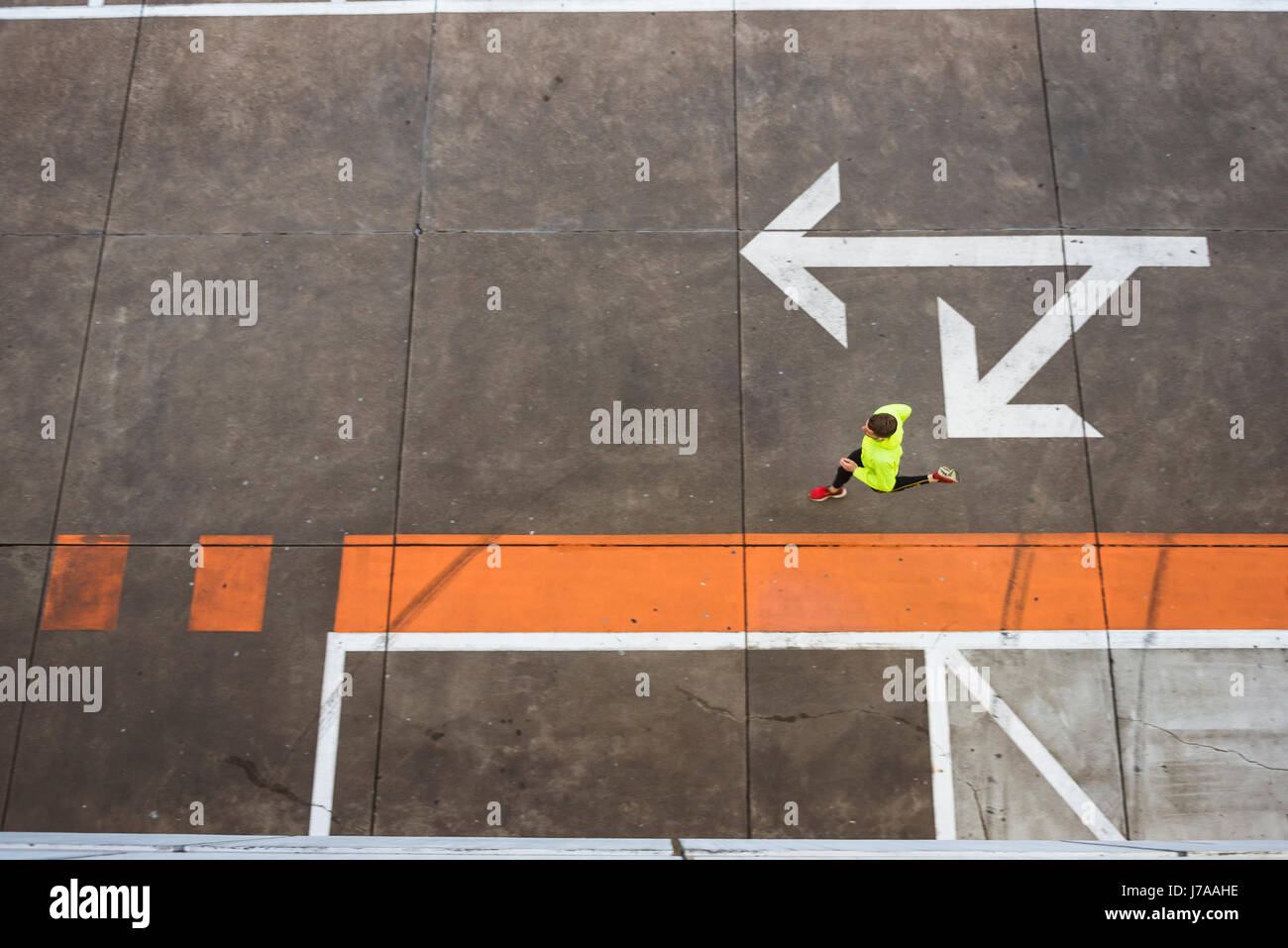 Young man running on parking level Stock Photo
