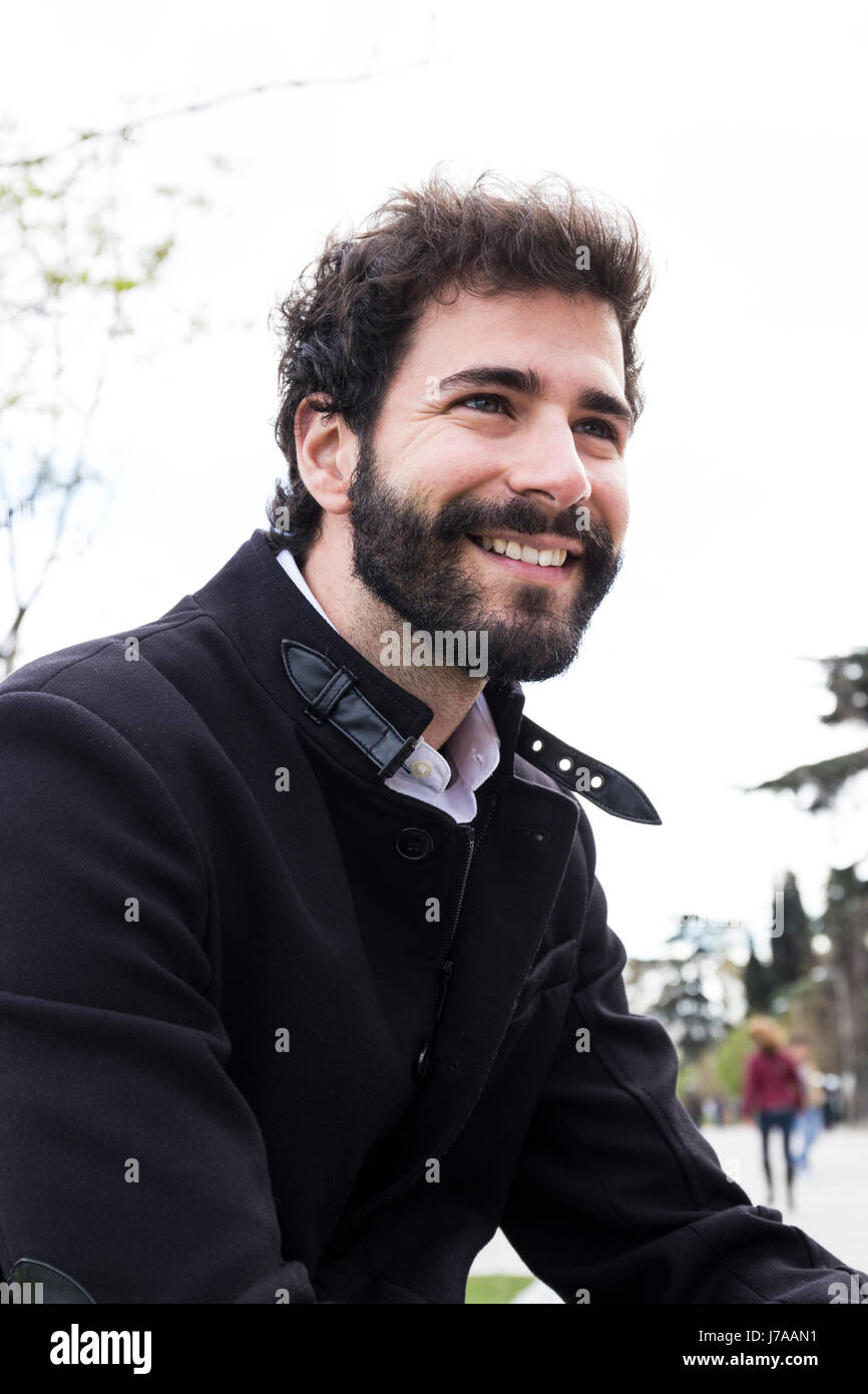 Portrait of smiling young man with full beard Stock Photo