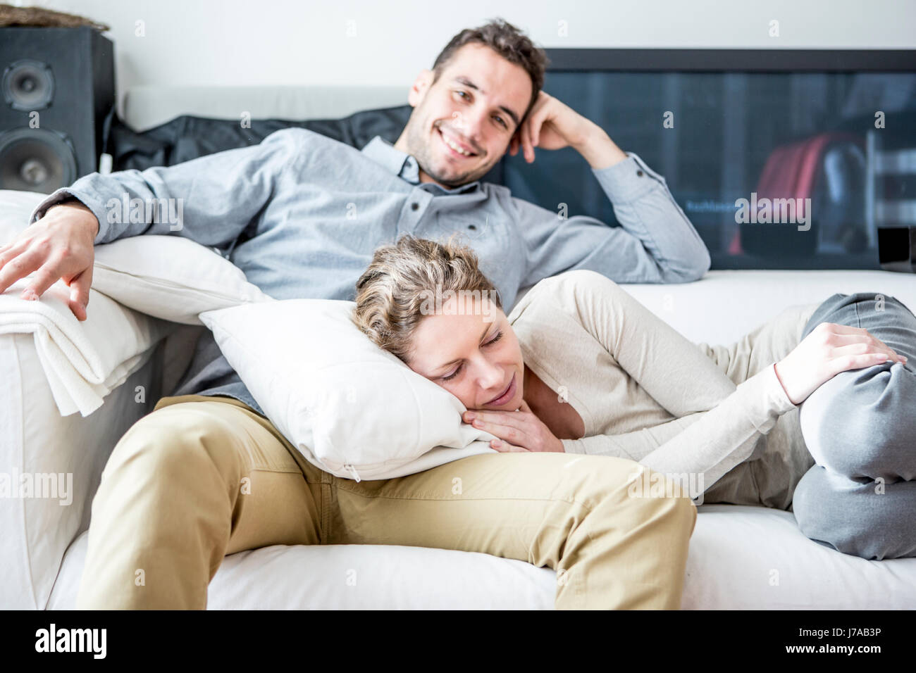 Couple relaxing on couch Stock Photo