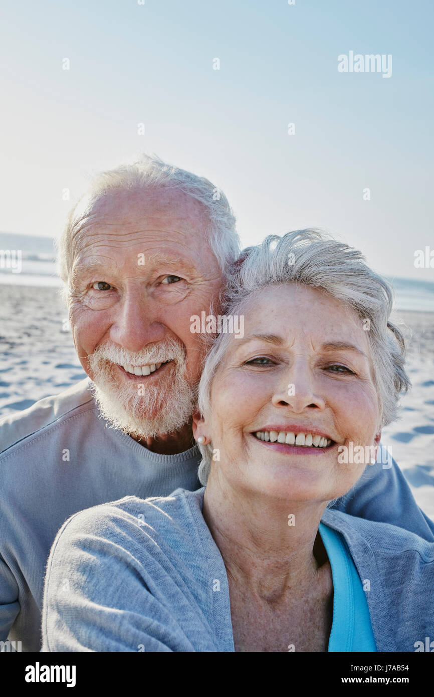 Portrait of smiling senior couple on the beach Stock Photo - Alamy