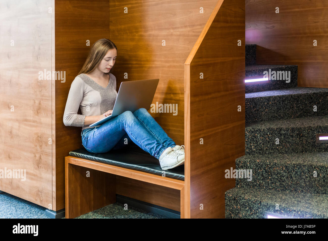 Teenage girl using laptop in a public library Stock Photo - Alamy