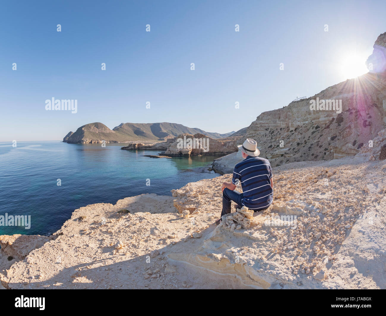 Spain, Andalusia, Cabo de Gata, back view of man looking at the sea Stock Photo