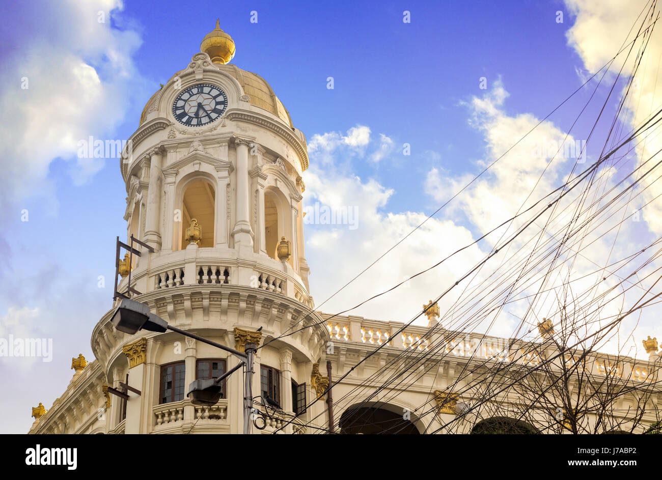 Vintage colonial architecture building dome and clock tower with a moody sunset sky. Photograph of vintage Metropolitan building at Kolkata, India. Stock Photo