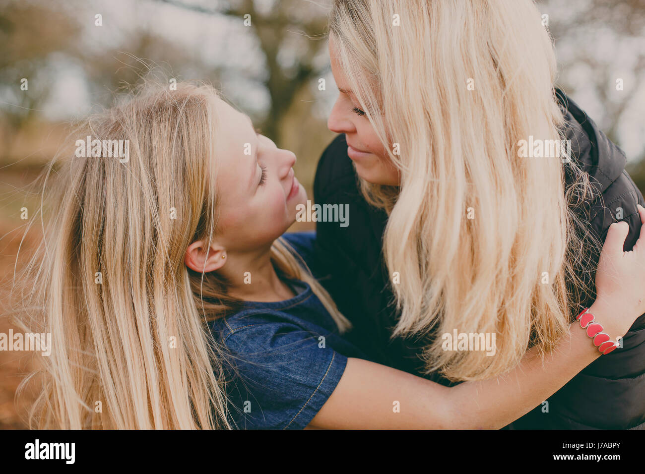 Mother and daughter smiling at each other Stock Photo