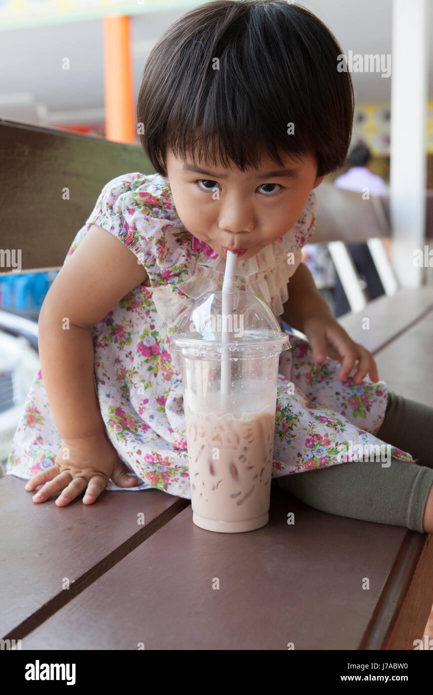 Download Children Drinking Chocolate Milk From Plastic Bottle And Looking To Stock Photo Alamy PSD Mockup Templates