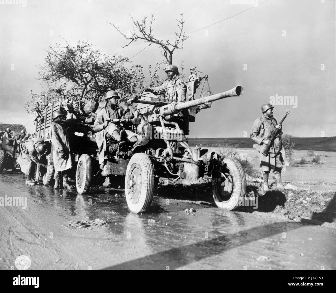 An artillery unit checks their equipment while the convoy takes a break, 1944. Stock Photo