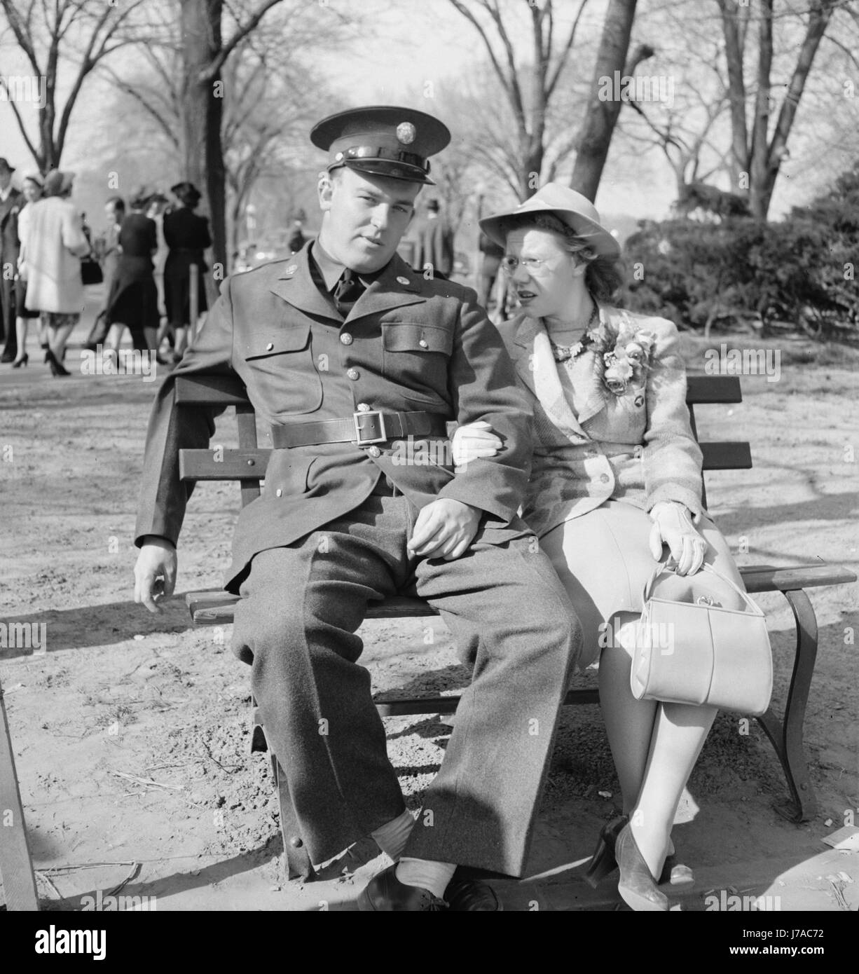 Soldier and friend sit on a park bench in Washington, D.C., 1941. Stock Photo