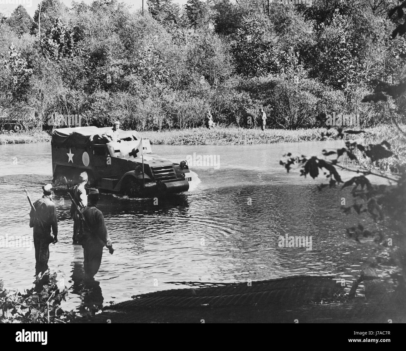 An armored half-track vehicle crossing the river, circa 1942. Stock Photo
