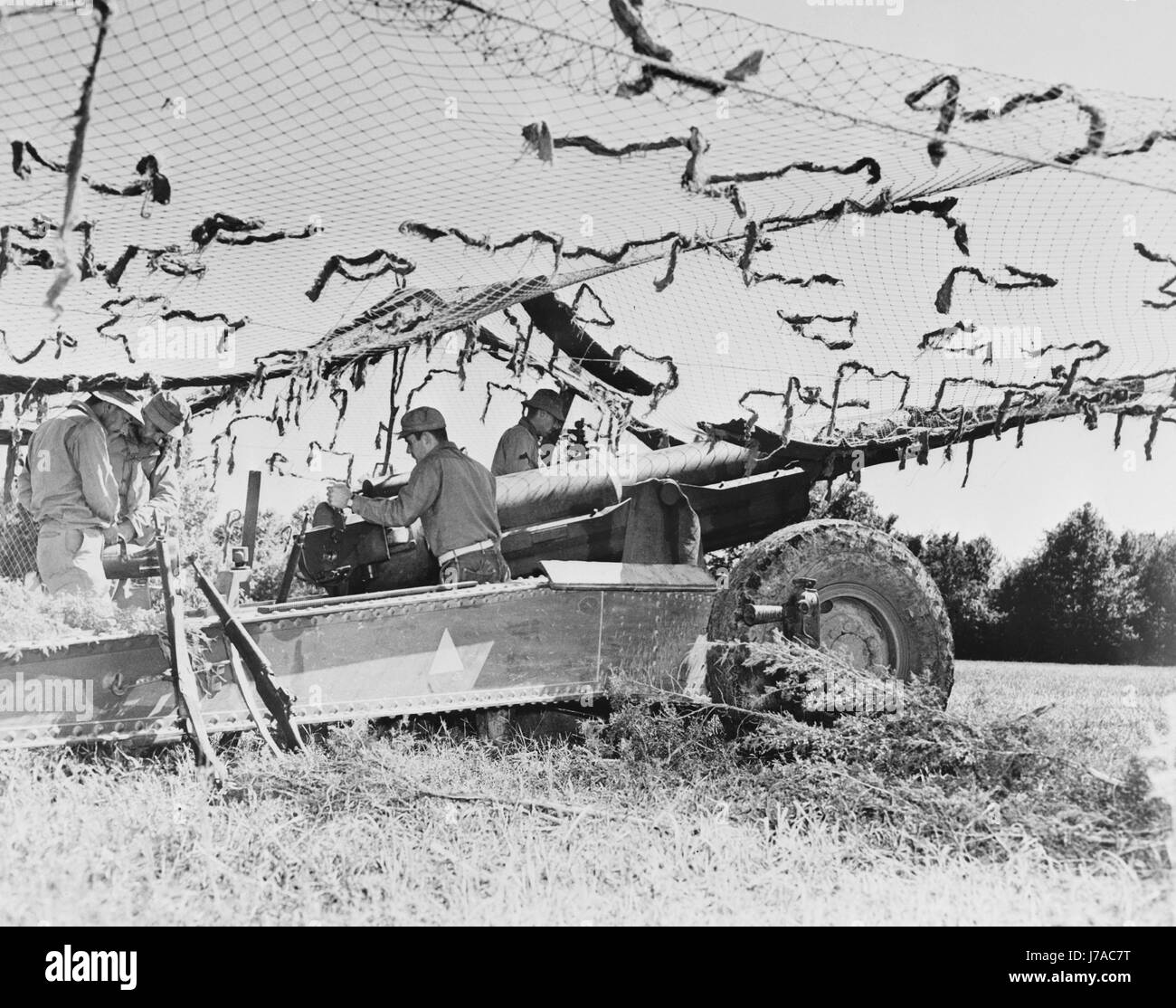 Members of a field artillery battery with their 155mm gun cleverly