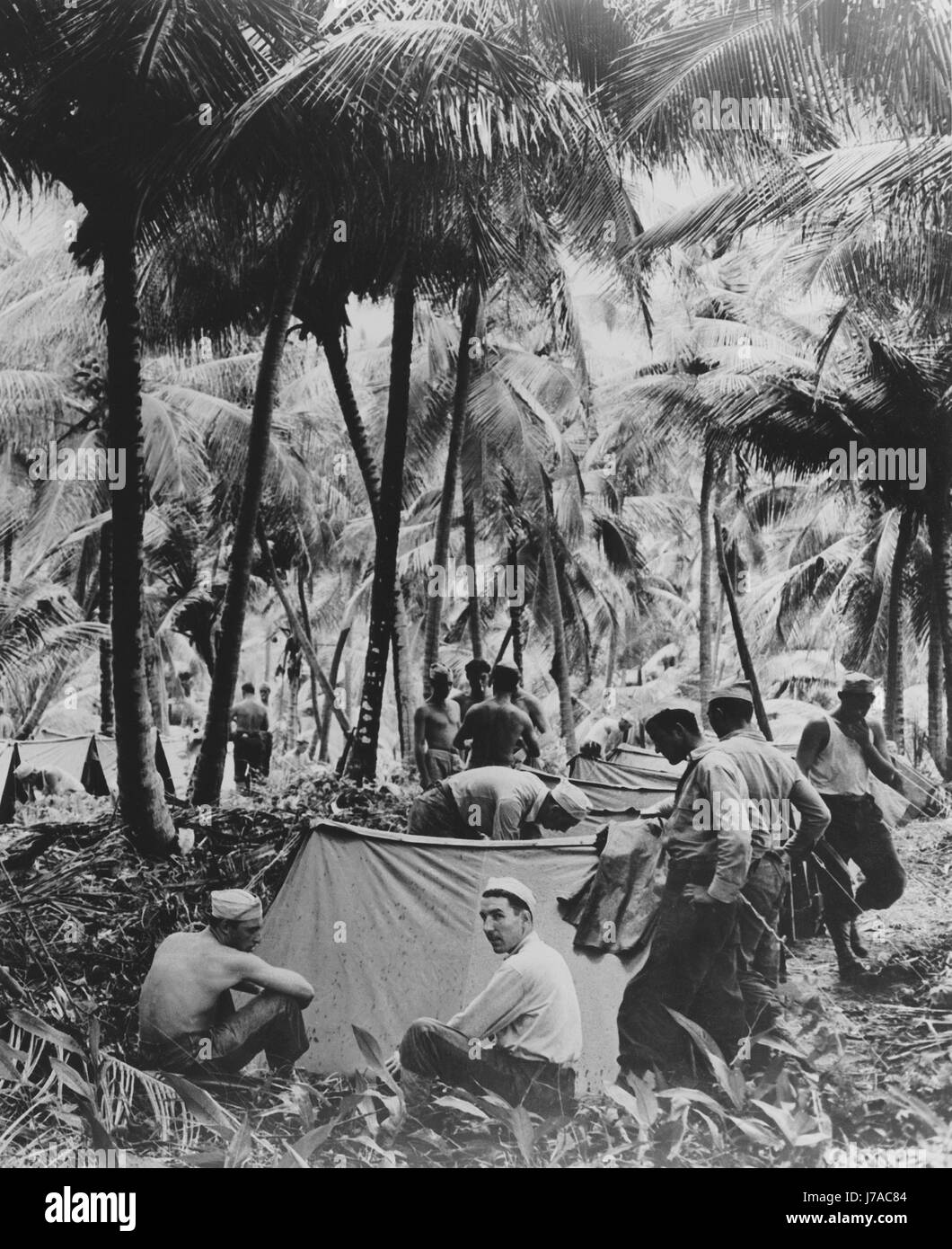U.S. soldiers in the Caribbean area peg down their shelter halves Stock Photo