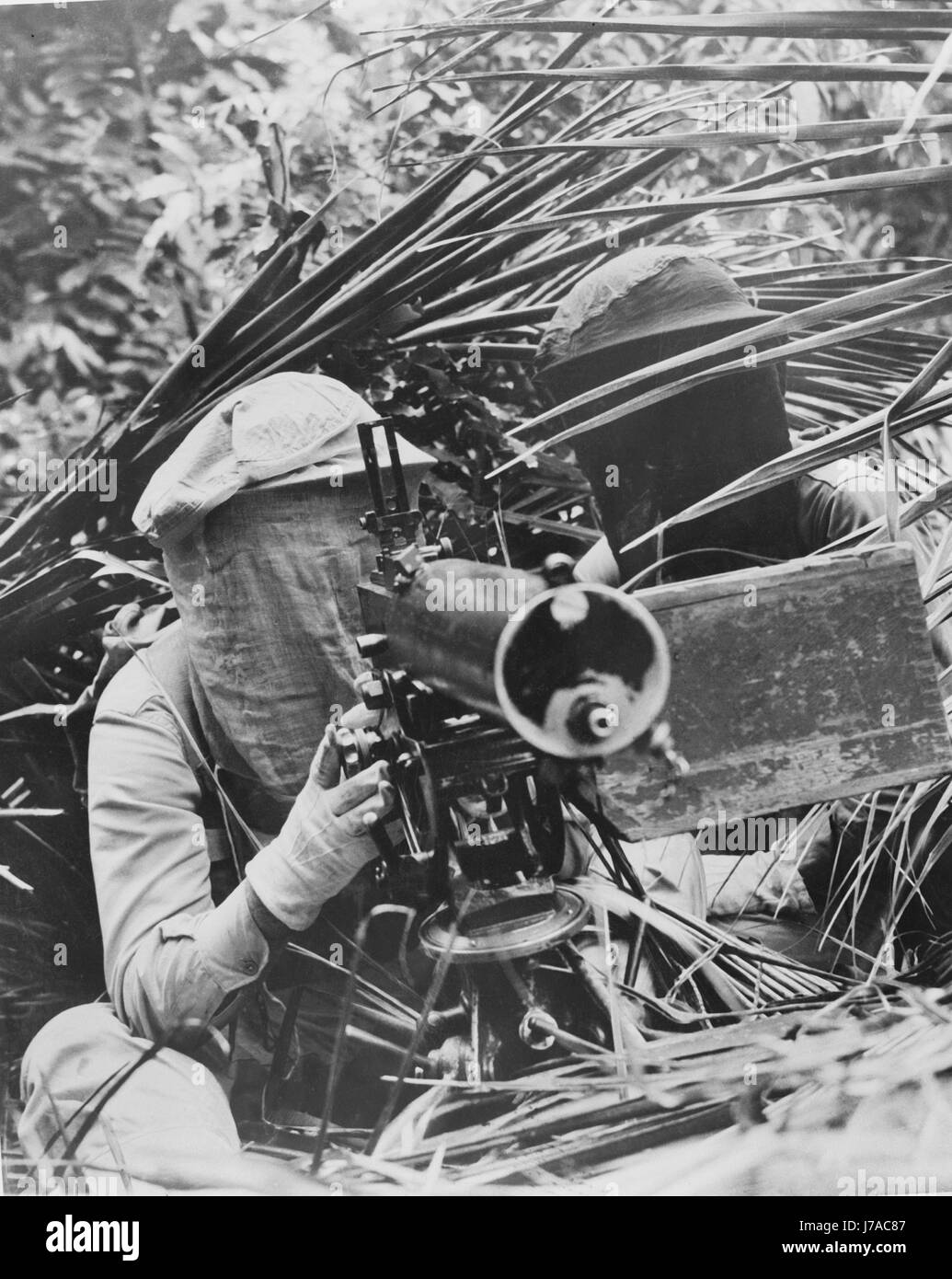 Machine gunners in the Caribbean area wearing head mosquito nets, circa 1942. Stock Photo