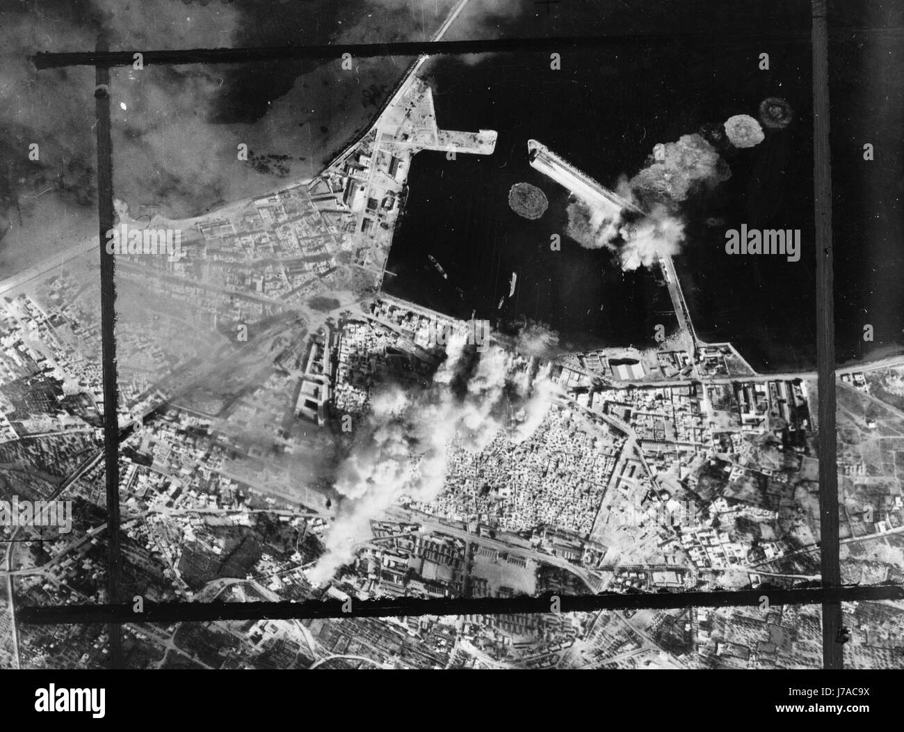 Aerial photograph showing direct bombing hits on a pierhead in Sousse, Tunisia, circa 1943. Stock Photo