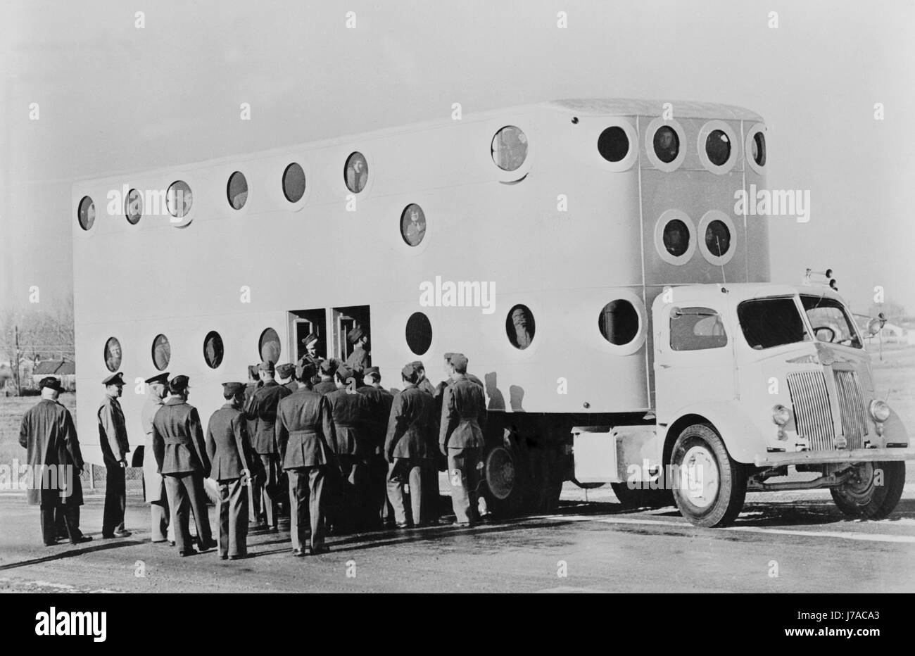 Soldiers boarding a white tractor semi-trailer at Camp Carson, Colorado, circa 1943. Stock Photo