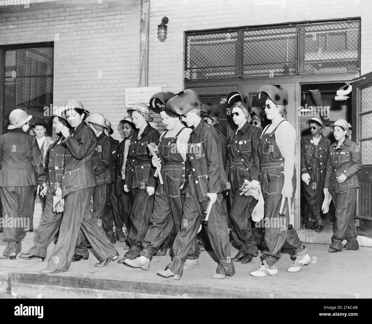 Women welders on the way to their job, circa 1943. Stock Photo