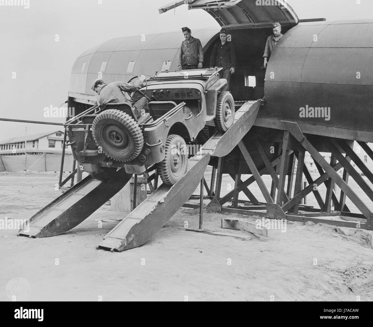 Men driving a jeep onto a plane at Fort Benning, circa 1942 Stock Photo Alamy