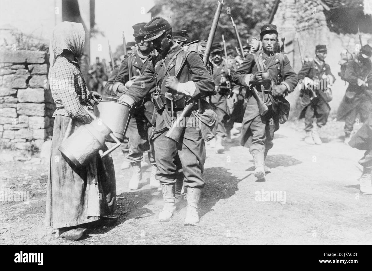 Peasant giving drink to French soldiers. Stock Photo
